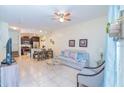 Open concept living room with a ceiling fan, tile floors, and stairs to the second floor at 2610 Lodi Cir # 104, Kissimmee, FL 34746