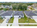 Aerial view of single-story homes with well-maintained lawns and ample parking space at 2872 Lingo Ln, Orlando, FL 32822