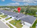 Aerial view of single-story homes with well-maintained lawns and ample parking space at 2872 Lingo Ln, Orlando, FL 32822