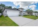 Charming single-story home with a spacious two-car garage and a neatly kept lawn at 2872 Lingo Ln, Orlando, FL 32822