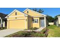 Beautiful home featuring a two car garage, complemented by well-maintained landscaping at 4357 Babbling Brook Way, Kissimmee, FL 34746
