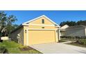 Side angle view of a lovely home with a two car garage and a well manicured lawn at 4357 Babbling Brook Way, Kissimmee, FL 34746