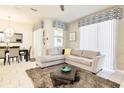 Bright and airy living room featuring a comfortable sectional sofa and stylish decor at 4888 Romeo Cir, Kissimmee, FL 34746