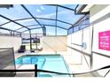 Inviting, screened-in pool area with lounge chairs and a clear blue sky overhead at 4888 Romeo Cir, Kissimmee, FL 34746