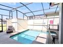 Private, screened-in pool and spa area with modern design and a relaxing lounge chair at 4888 Romeo Cir, Kissimmee, FL 34746
