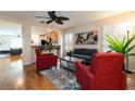 Open living room with a ceiling fan and a view into the kitchen, providing a seamless entertaining space at 5101 Staniard Dr, Kissimmee, FL 34746