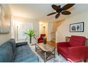 Comfortable living room featuring a ceiling fan, natural light, and modern furnishings at 5101 Staniard Dr, Kissimmee, FL 34746