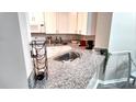 Stylish kitchen with granite countertops, stainless steel sink, and ample cabinet space at 5560 Metrowest Nw Blvd # 106, Orlando, FL 32811