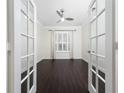 Home office with French doors, hardwood floors, and large window at 8374 Bowden Way, Windermere, FL 34786