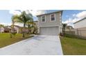 Two-story home with a two car garage, long driveway, and a well kept lawn at 905 Gloucester Ct, Kissimmee, FL 34758