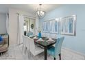 Stylish dining room with modern lighting, seating for eight, and patio access at 9075 Dogleg Dr, Davenport, FL 33896