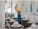 Dining table set with elegant white place settings and centerpiece at 9075 Dogleg Dr, Davenport, FL 33896