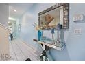 Bright foyer with a mirrored console table, decor, and security system at 9075 Dogleg Dr, Davenport, FL 33896