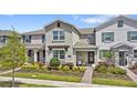 Attractive townhome with manicured landscaping, covered entry, and a cozy curb appeal at 11473 Listening Dr, Orlando, FL 32832