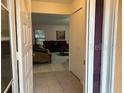 Inviting entryway leading into a cozy living space with tiled floors and neutral decor at 133 Bianca Ct, Kissimmee, FL 34758