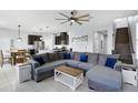 Open-concept living room featuring tile floors, a large sectional sofa, and seamless flow to the kitchen at 1338 Riley Cir, Deland, FL 32724
