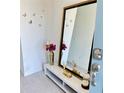 A stylish entryway with a large mirror, accent decor, and a modern aesthetic at 1868 Sanibel Dr, Davenport, FL 33896