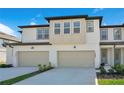 Inviting townhome exterior with a two-car garage and manicured landscaping at 1868 Sanibel Dr, Davenport, FL 33896