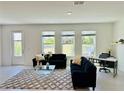 Inviting living room with large windows overlooking a scenic pond view at 1868 Sanibel Dr, Davenport, FL 33896