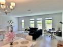 Bright living area with modern furnishings, large windows, and stylish decor at 1868 Sanibel Dr, Davenport, FL 33896