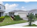 Beautiful single-story home with well-maintained landscaping and a two-car garage at 1872 Summer Serenity Dr, Kissimmee, FL 34744