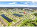 A beautiful aerial view of a residential community with ponds and green spaces surrounding the homes at 18863 Rawson St, Orlando, FL 32827