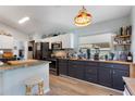 Well-equipped kitchen features a breakfast bar, stainless steel appliances, and ample countertop space at 219 Breezy Oaks Ct, Davenport, FL 33896