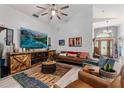 Inviting living room with modern furnishings, a wooden entertainment center, and neutral decor at 219 Breezy Oaks Ct, Davenport, FL 33896