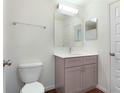 The bathroom features a stylish single vanity, framed mirror, and modern fixtures at 250 Beckenham Dr, Kissimmee, FL 34758