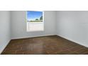 Cozy bedroom with tile floors and a view of the fenced backyard at 250 Beckenham Dr, Kissimmee, FL 34758