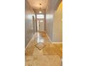 Inviting foyer with light tile flooring and transom window above the front door at 2713 Barnsley Ln, Kissimmee, FL 34744