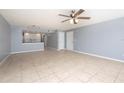 Open-concept living space with tile flooring, leading to a bright kitchen and multiple doorways at 2725 N Poinciana Blvd # 147, Kissimmee, FL 34746