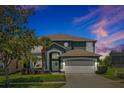 Beautiful two-story home with a well-manicured lawn, mature landscaping, and a two-car garage at 2747 Lido Key Dr, Kissimmee, FL 34747