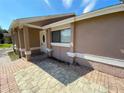 The home's front entrance with pavers, neutral paint scheme, and a covered entryway at 308 S Shadow Bay Dr, Orlando, FL 32825