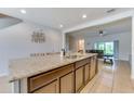 Spacious kitchen with a large island, granite countertops, stainless steel appliances, and an open floor plan at 314 Annabelle Way, Davenport, FL 33837