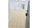 Open living area with tile floors, white walls, and an open concept to the kitchen at 3300 Whitestone Cir # 201, Kissimmee, FL 34741