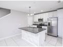 Modern kitchen boasts stainless steel appliances, granite countertops, and a stylish island at 3470 Beau Rd, Kissimmee, FL 34746