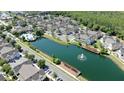 Stunning aerial view of townhomes, a sparkling pool, and a tranquil pond with fountain at 4004 Santa Maria Dr # 108, Kissimmee, FL 34741