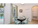 Charming dining area with a view of the pool, plus stylish table and seating at 4072 Oaktree Dr, Davenport, FL 33837