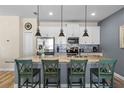 Modern kitchen featuring an island with granite countertops and pendant lighting at 4907 Romeo Cir, Kissimmee, FL 34746