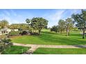 Expansive view of the lush green golf course showcasing the community's beautiful landscaping at 7683 Heritage Crossing Way # 202, Reunion, FL 34747