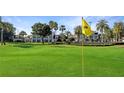 Scenic golf course view with manicured greens and mature trees, perfect for golf enthusiasts and outdoor enjoyment at 7683 Heritage Crossing Way # 202, Reunion, FL 34747
