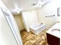 Bright bathroom featuring a soaking tub and large vanity at 7716 Park Hill Ave, Leesburg, FL 34748