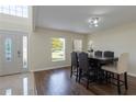 Bright dining room featuring hardwood floors, a modern light fixture, and an inviting atmosphere at 7716 Park Hill Ave, Leesburg, FL 34748
