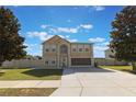 Beautiful two-story home showcasing a manicured lawn, large driveway, and well-maintained neutral-colored exterior at 7716 Park Hill Ave, Leesburg, FL 34748