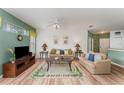 Relaxing living area with a comfortable seating, a TV, and hardwood flooring at 8923 Legacy Ct # 19-102, Kissimmee, FL 34747