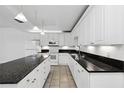 Bright kitchen featuring white cabinets, granite countertop and island at 1999 Grand Oak Dr, Kissimmee, FL 34744