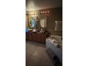 Elegant bathroom with double sinks, wood cabinets, a soaking tub, and updated fixtures at 639 Gull Dr, Poinciana, FL 34759