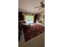 Inviting living room featuring a plush sofa, patterned rug, and sliding doors to a refreshing outdoor pool at 639 Gull Dr, Poinciana, FL 34759