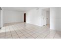 Bright living room with white tile flooring and ample natural light showcases a clean aesthetic at 1038 Plantation Dr # D9, Kissimmee, FL 34741